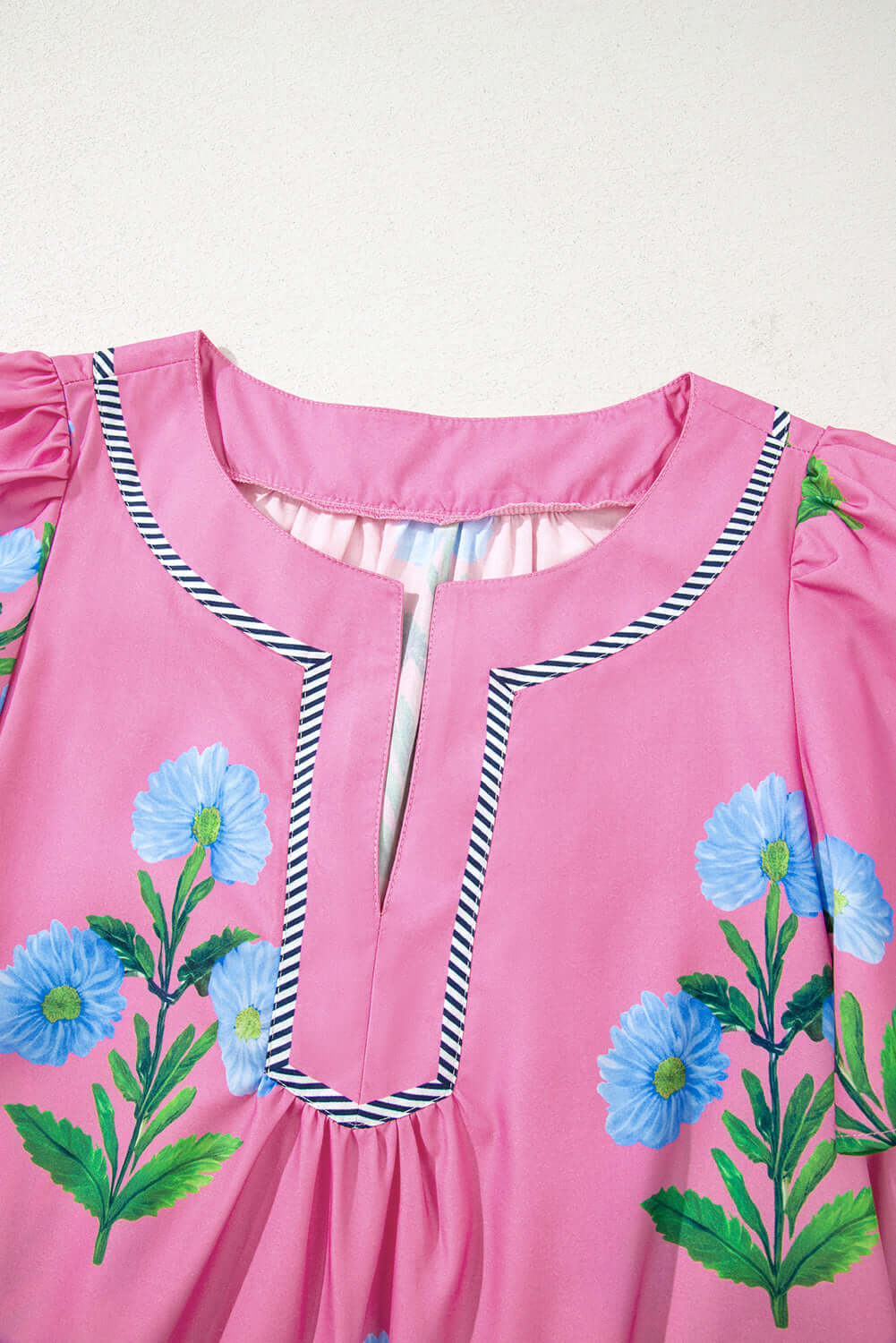 Close-up of the Coastal Kiss Dress in magenta, featuring a floral print and contrast trim details.