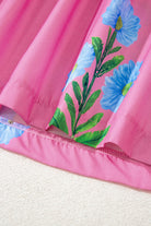 Coastal Kiss Dress in magenta with blue floral print detail, perfect for sunny days and seaside strolls.