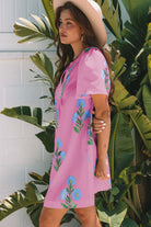 Coastal Kiss Dress in magenta with floral print, worn by a model, perfect for sunny days and seaside strolls.