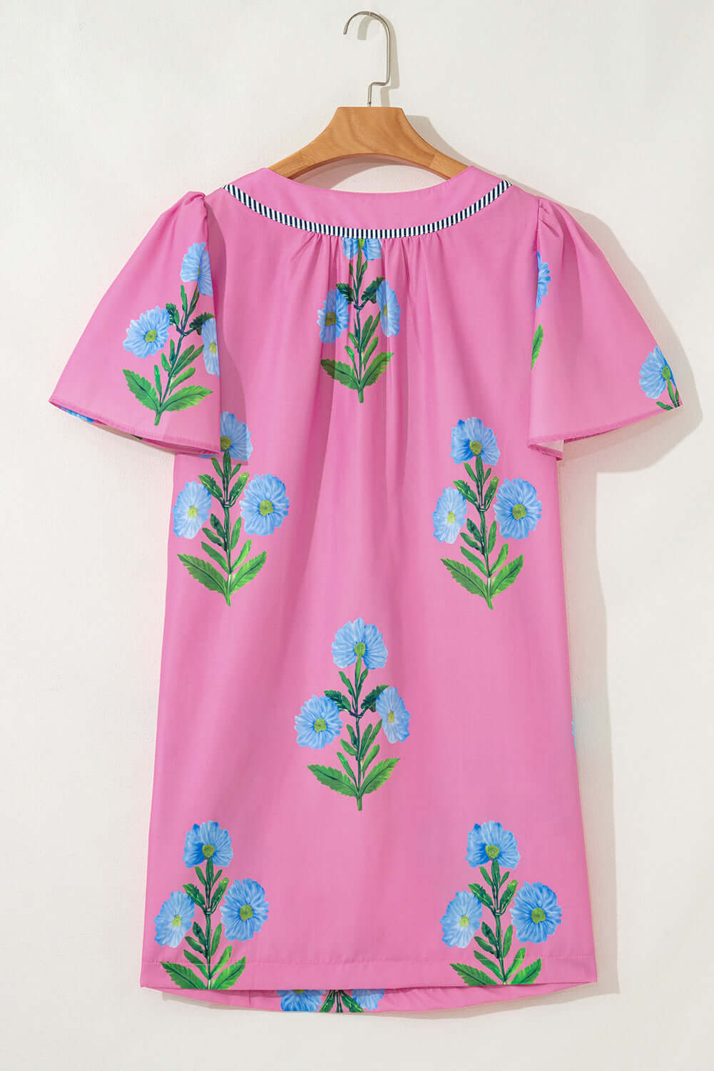 Coastal Kiss Dress in magenta with floral print, perfect for sunny days and seaside strolls.