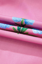 Close-up of lightweight magenta fabric with vibrant blue floral pattern, ideal for summer dresses.