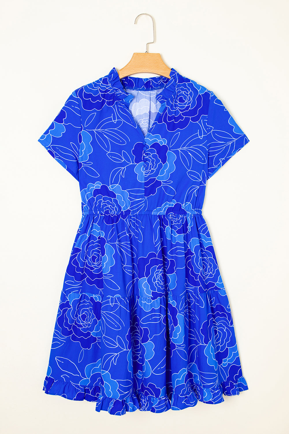 Bright blue floral dress with short sleeves and a tiered skirt on a hanger.