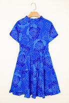 Back view of the Blue Crush Dress featuring a floral design, tiered skirt, and short sleeves in vibrant cobalt blue.