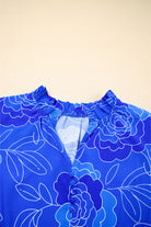 Close-up of the Blue Crush Dress showing vivid cobalt floral print and V-neckline design.