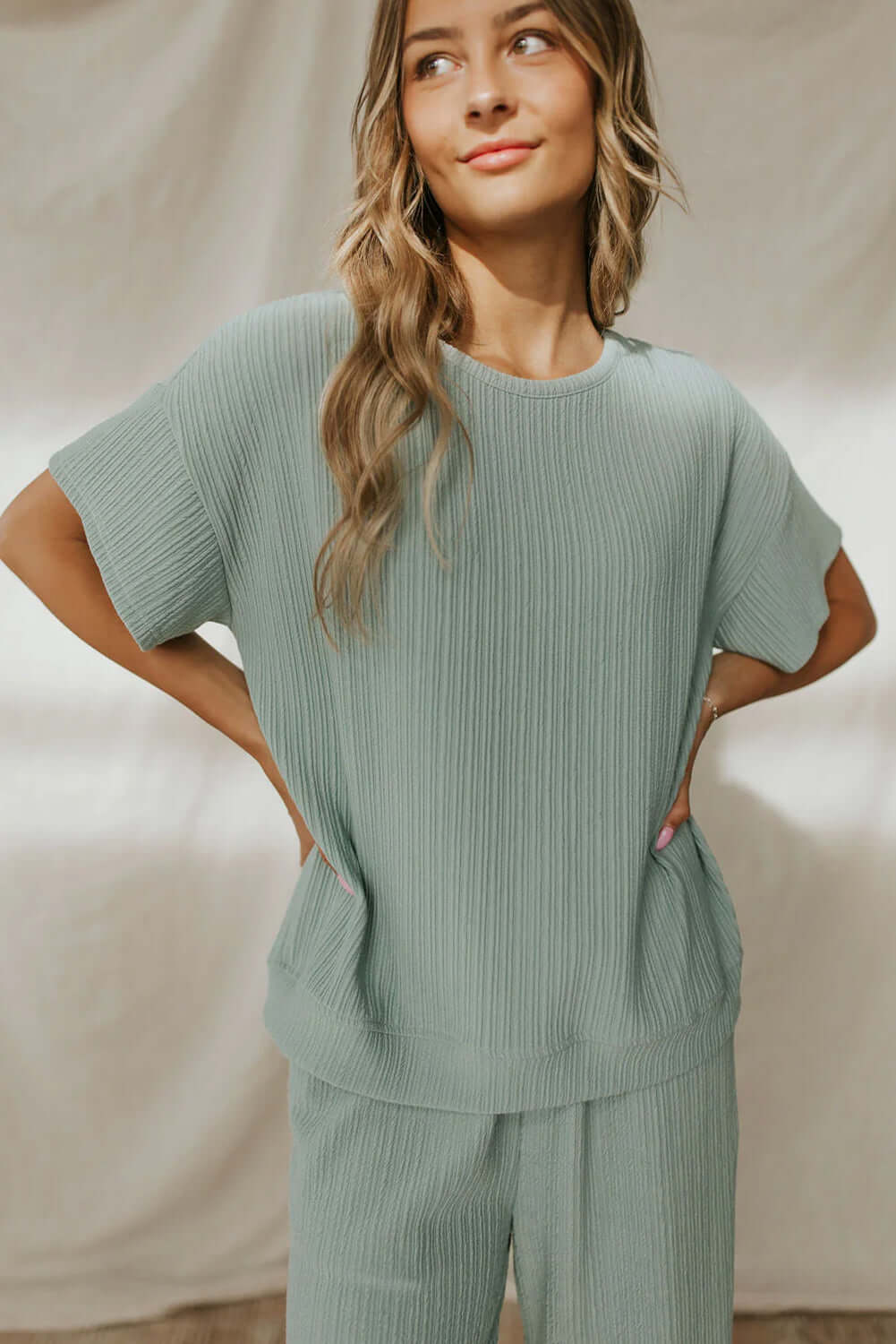 Woman wearing FULLY JADED SET in minty jade green, showcasing its textured design for elegance and comfort.