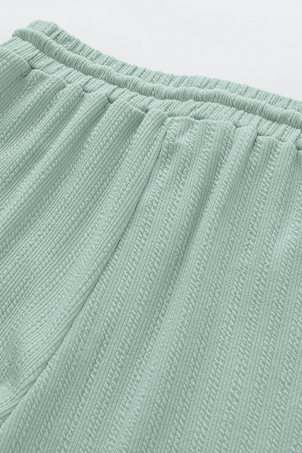 Minty jade green textured lounge set pants, luxurious and stylish, made by [Brand Name], 95% polyester, 5% elastane.