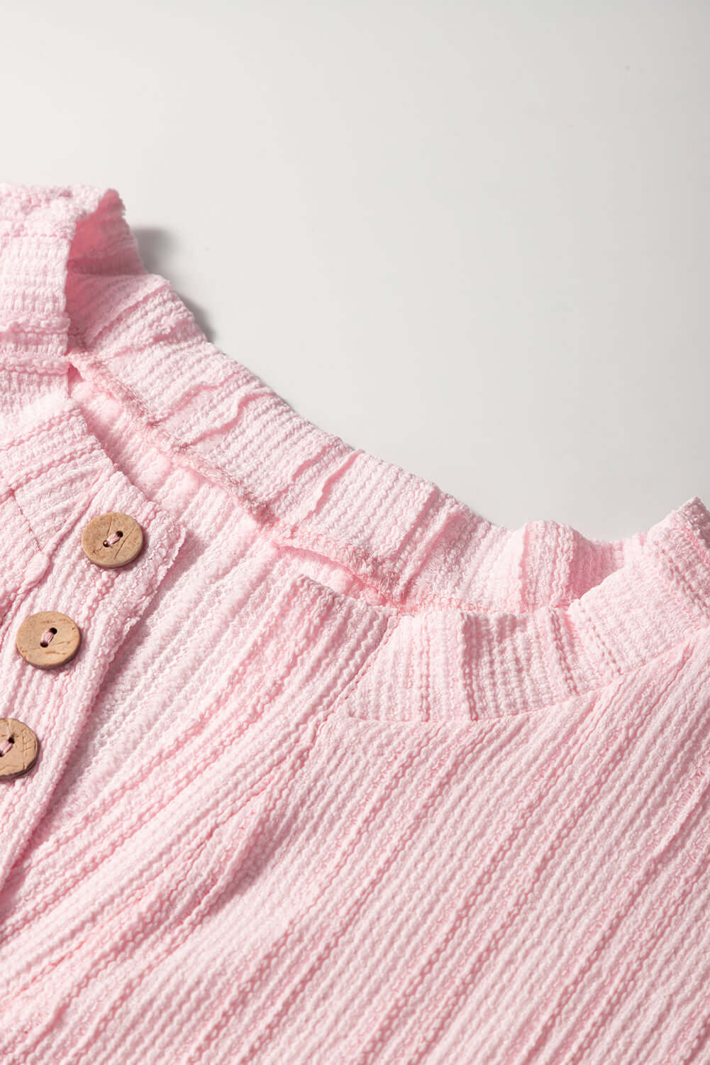 Close-up of soft pink textured Henley top with button details from the Soft Serenade Set.