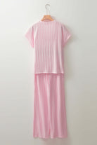 Soft Serenade Set: Light pink textured two-piece outfit with short sleeves and wide-leg pants.