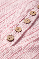 Close-up of textured pink fabric with wooden buttons, part of the Soft Serenade Set outfit.