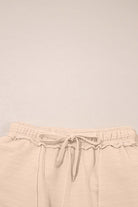Close-up of elastic waistband shorts from Champagne Chill 2 Piece Set, showcasing soft beige fabric and tie details.