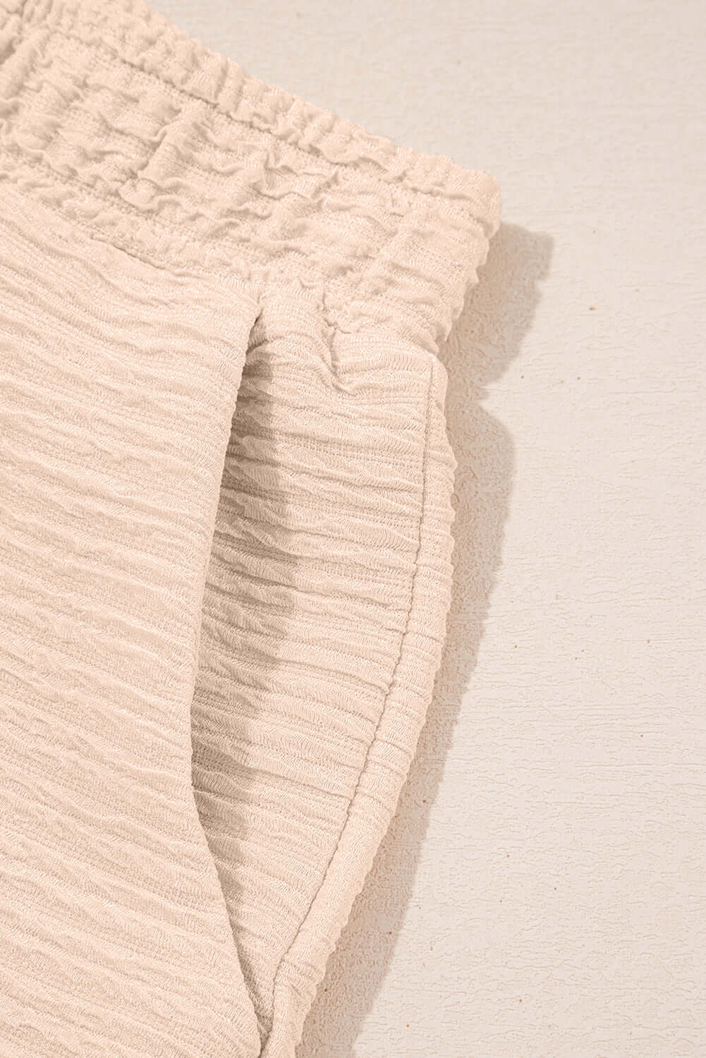 Close-up of textured beige shorts with elastic waistband from the Champagne Chill 2 Piece Set.