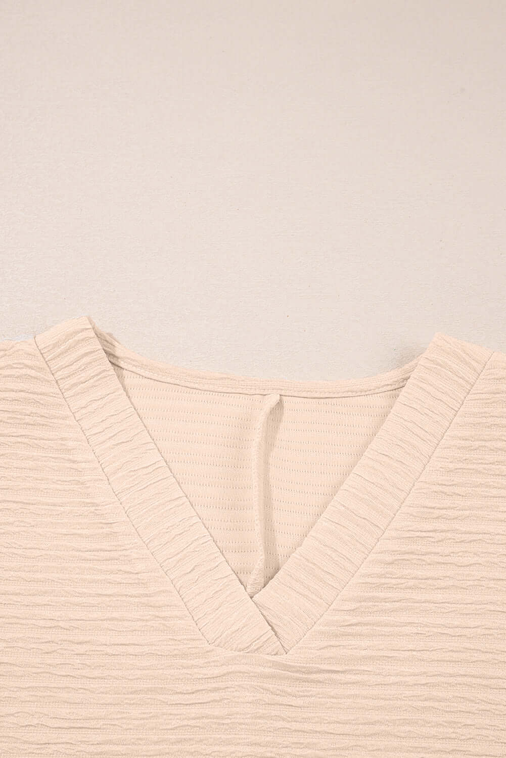 Close-up of textured cream V-neck top from the Champagne Chill two-piece set.