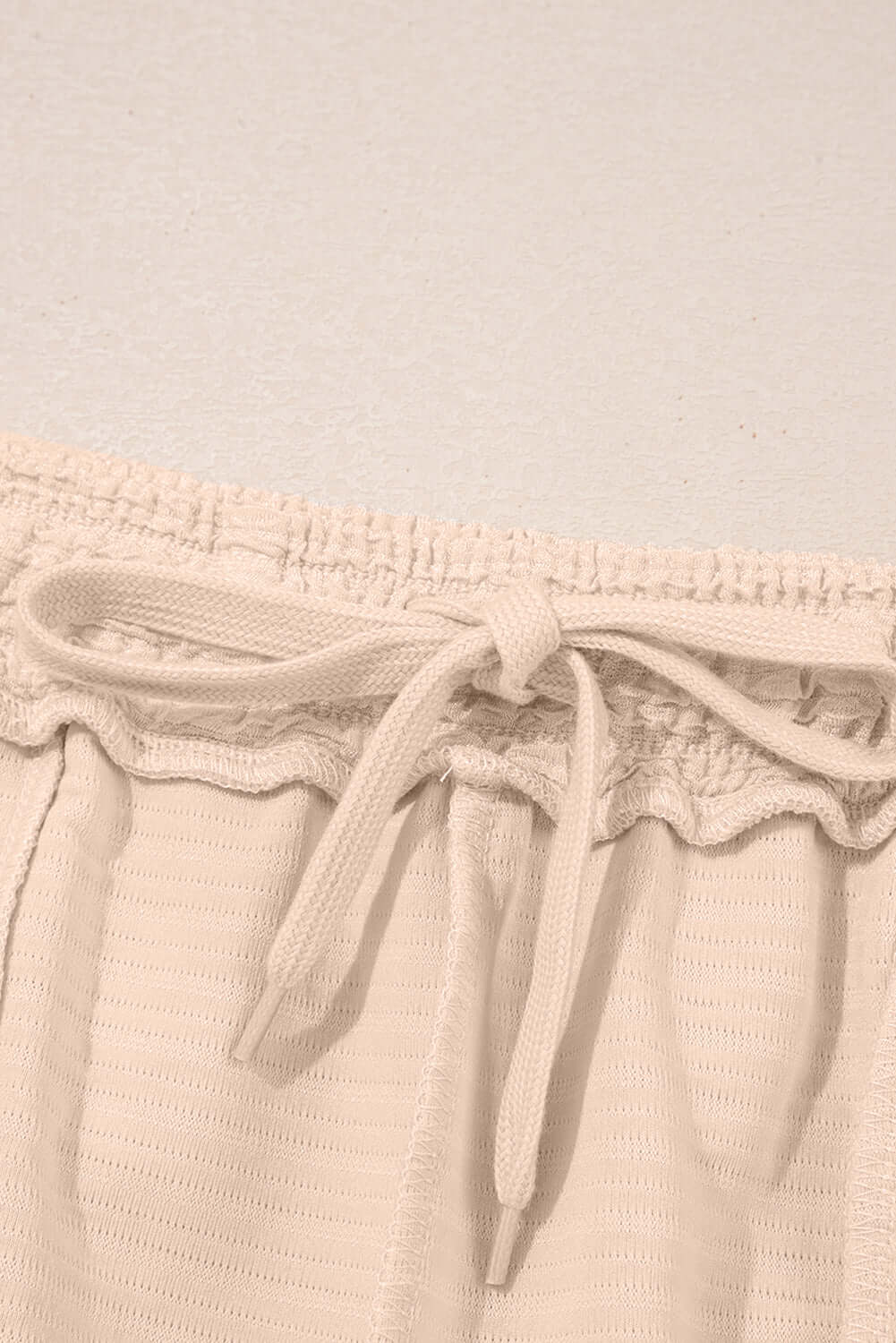 Close-up of elastic waistband with drawstring on beige shorts from Champagne Chill 2 Piece Set.
