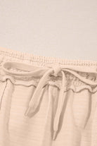 Close-up of elastic waistband with drawstring on beige shorts from Champagne Chill 2 Piece Set.