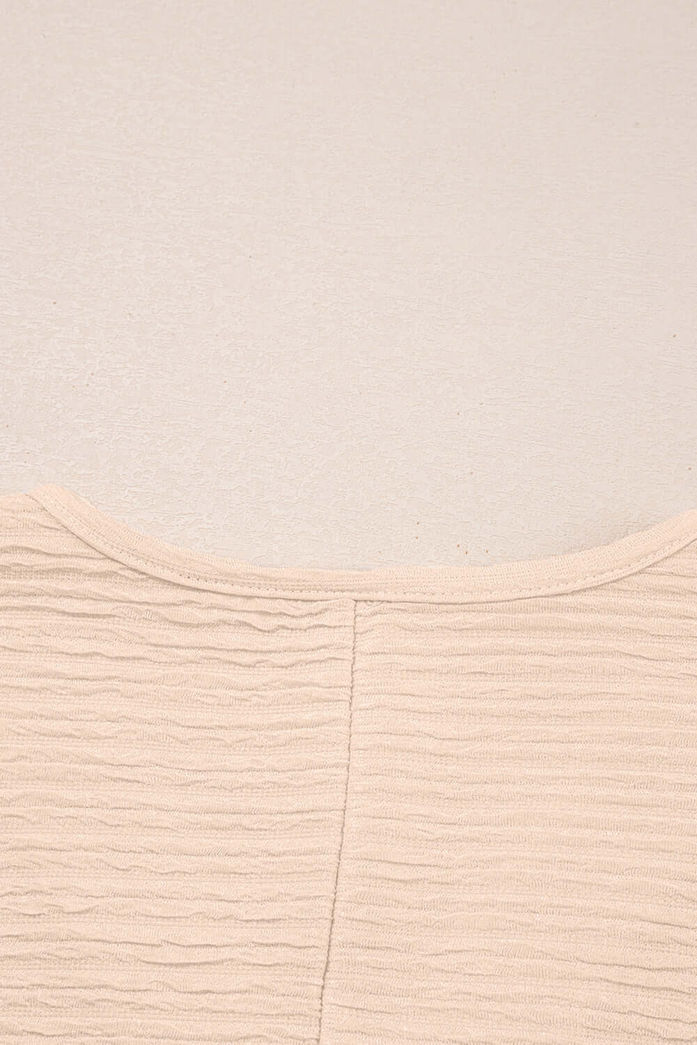 Textured beige fabric close-up of top from Champagne Chill two-piece set, showcasing its soft and stylish design.