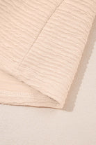 Textured fabric of a beige two-piece set, showcasing soft and cozy material perfect for casual wear.