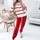 Woman in red pants and striped top from the TRUE STRIPES SET, showcasing comfortable loungewear style.