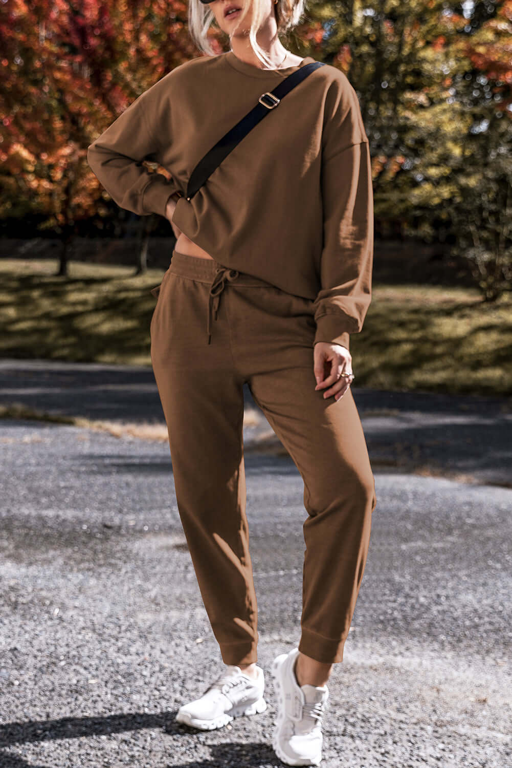 Model wearing Elemental Energy Set in cocoa, featuring a relaxed fit sweatshirt and matching lounge pants. Stylish and comfortable outfit.