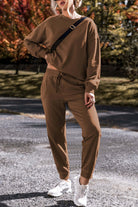 Model wearing Elemental Energy Set in cocoa, featuring a relaxed fit sweatshirt and matching lounge pants. Stylish and comfortable outfit.