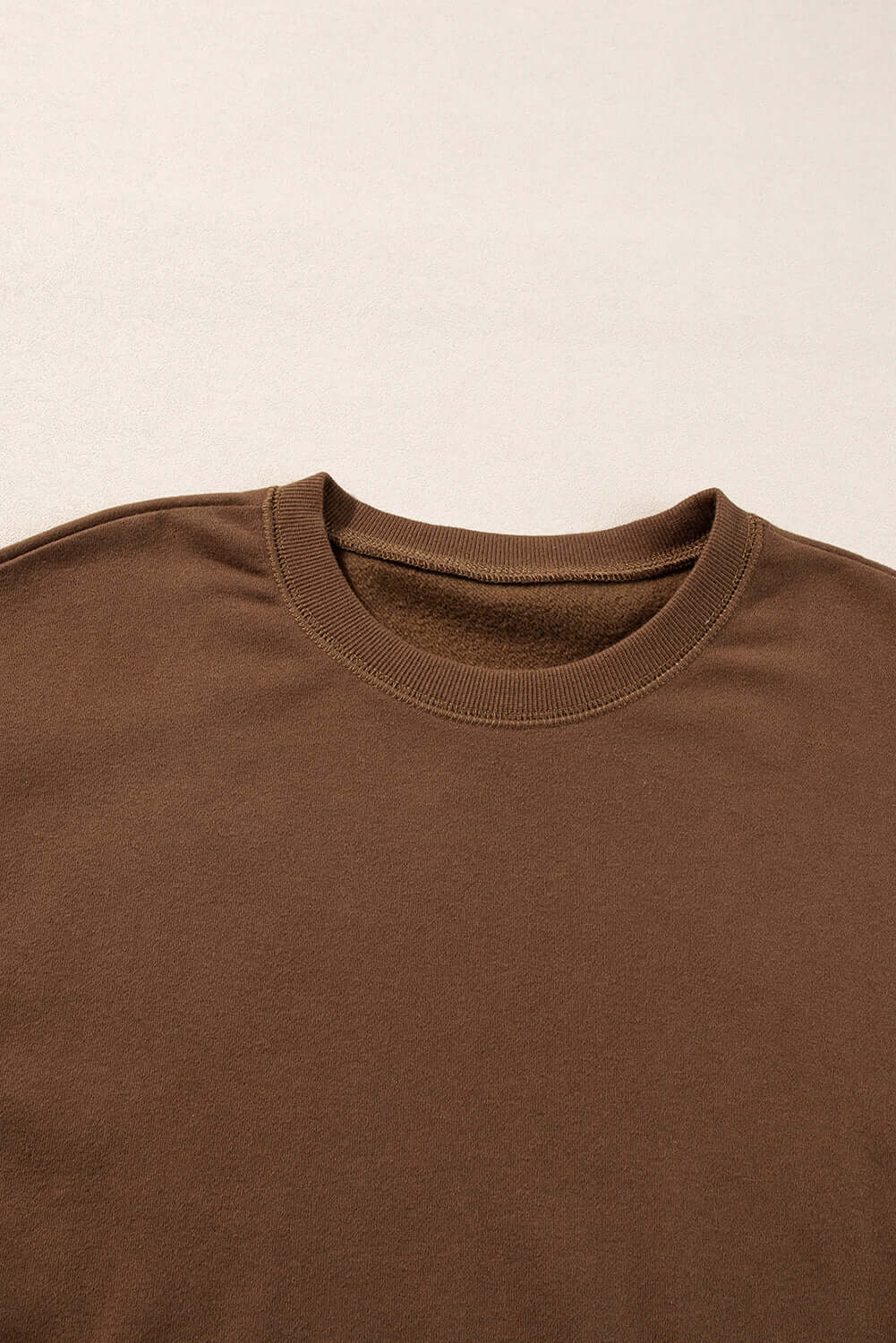 Close-up of cozy cocoa crew neck pullover from the Elemental Energy Set, featuring a relaxed fit and soft fabric.