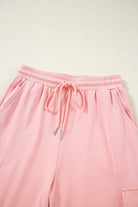 Close-up of Pink Cloud cargo sweatpants featuring an elastic waistband and side pockets. Perfect for comfort and style.