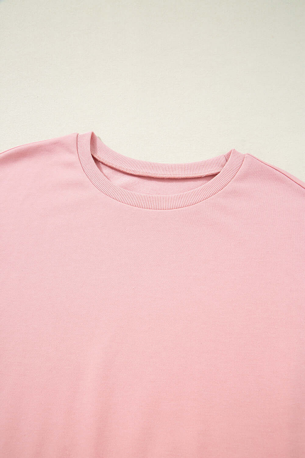 Close-up of the Pink Cloud half sleeve tee featuring a soft pink color and classic crew neck design.