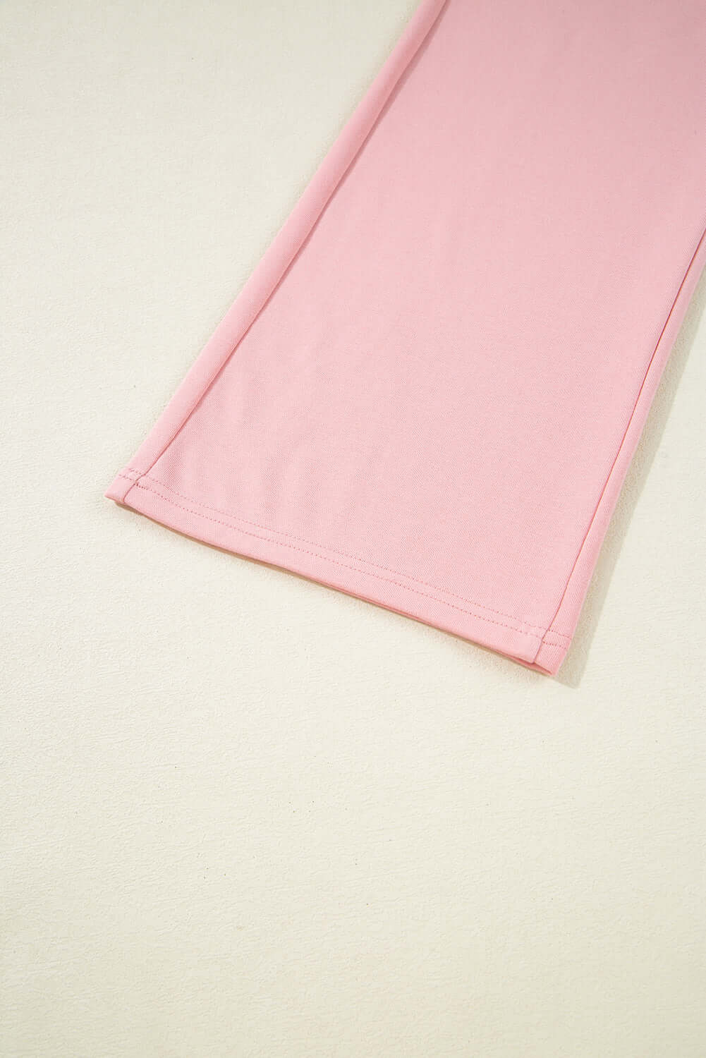 Close-up of the soft pink fabric and hem of the Pink Cloud cargo sweatpants, showcasing casual style and comfort.