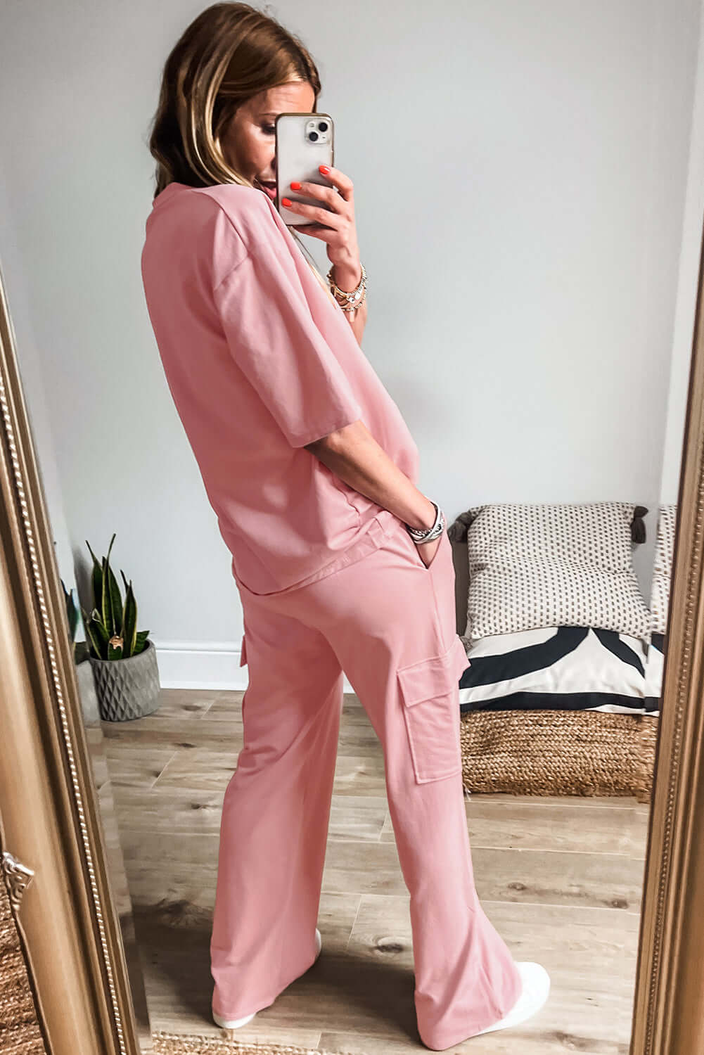 Model showcasing stylish Pink Cloud 2-piece lounge set with half sleeve tee and cargo sweatpants.