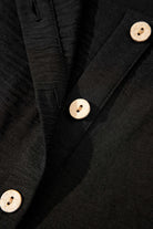Close-up of black vest showing wooden buttons and textured fabric in the Oasis Moment 2 Piece Pants Set.