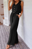 Chic black 2-piece pants set featuring a buttoned crop vest and wide-leg pants, perfect for effortless elegance.