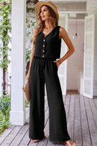 Oasis Moment 2-piece black pants set featuring buttoned crop vest and wide-leg pants in a stylish outdoor setting.