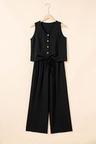 Oasis Moment black 2-piece set featuring a buttoned crop vest and wide-leg pants hung on a hanger.