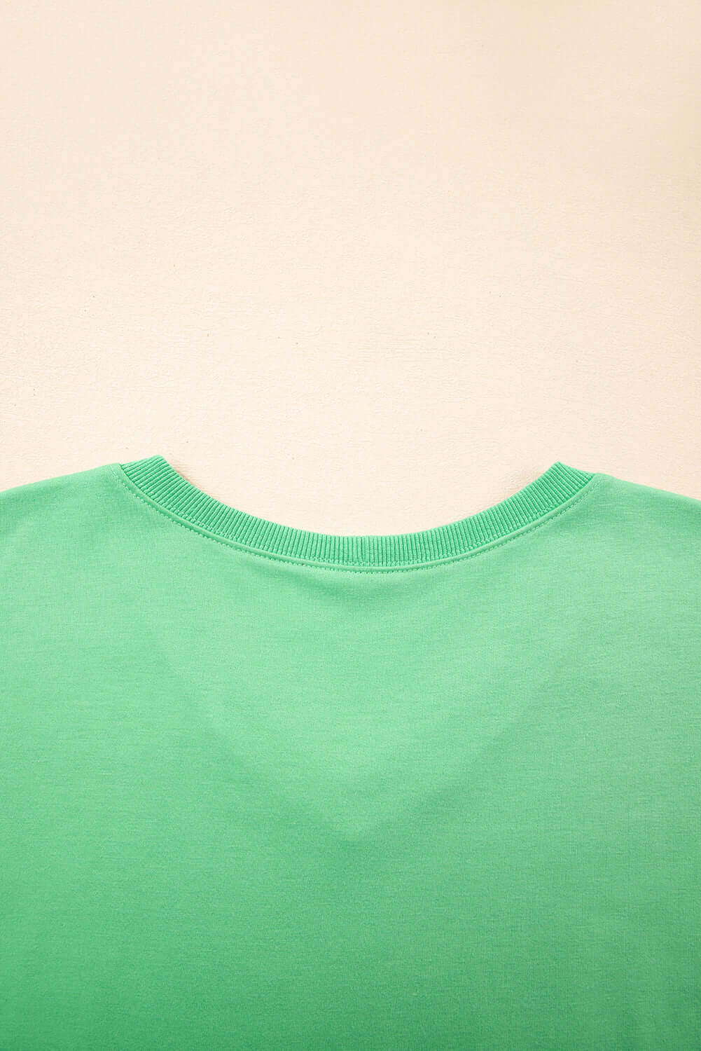 Back view of a bright green V-neck tee from the Zest for Life shorts set for summer styling.