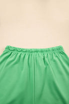 Bright green shorts with elastic waistline for comfortable summer style.