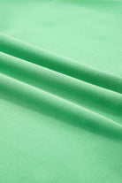 Bright green fabric showcasing a smooth texture, perfect for warm-weather clothing like the Zest for Life shorts set.