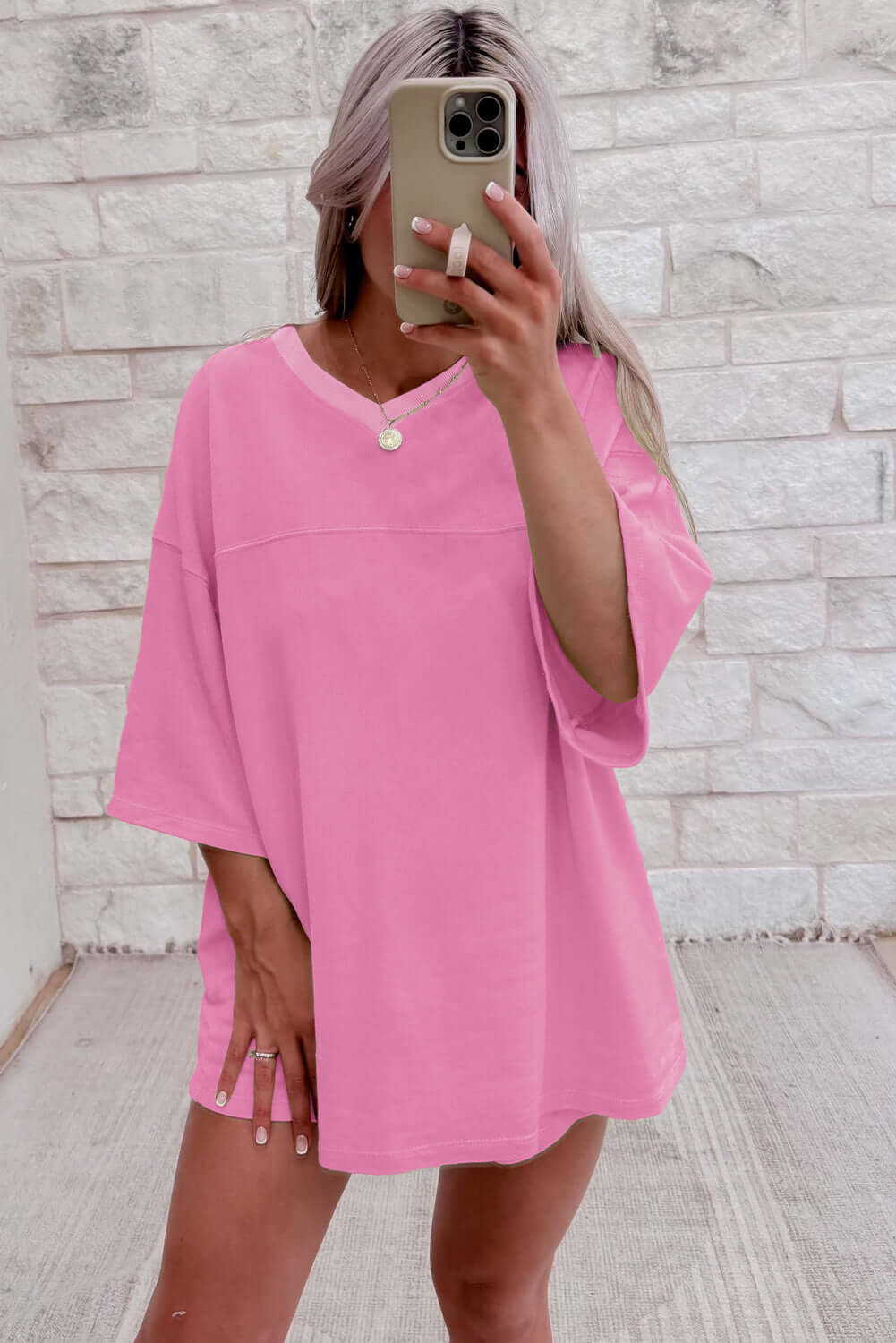 Model wearing oversized bonbon pink V-neck top from Barefoot Bliss Set, showcasing comfy, casual style.
