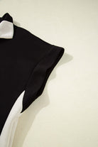 Close-up of the Monochrome Motion Set top in black and cream with a zip collar.