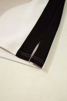 Close-up of the black and cream colorblock design with side slits from the METRO MODE Shorts Set.
