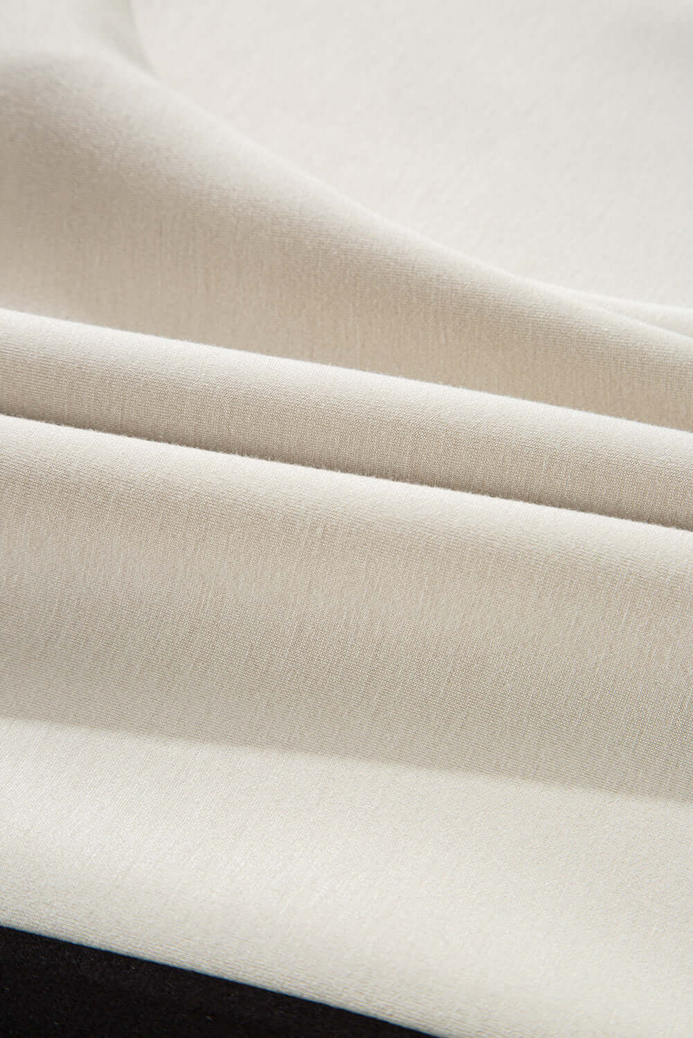 Close-up of soft, cream-colored fabric showcasing texture for the METRO MODE SHORTS SET.