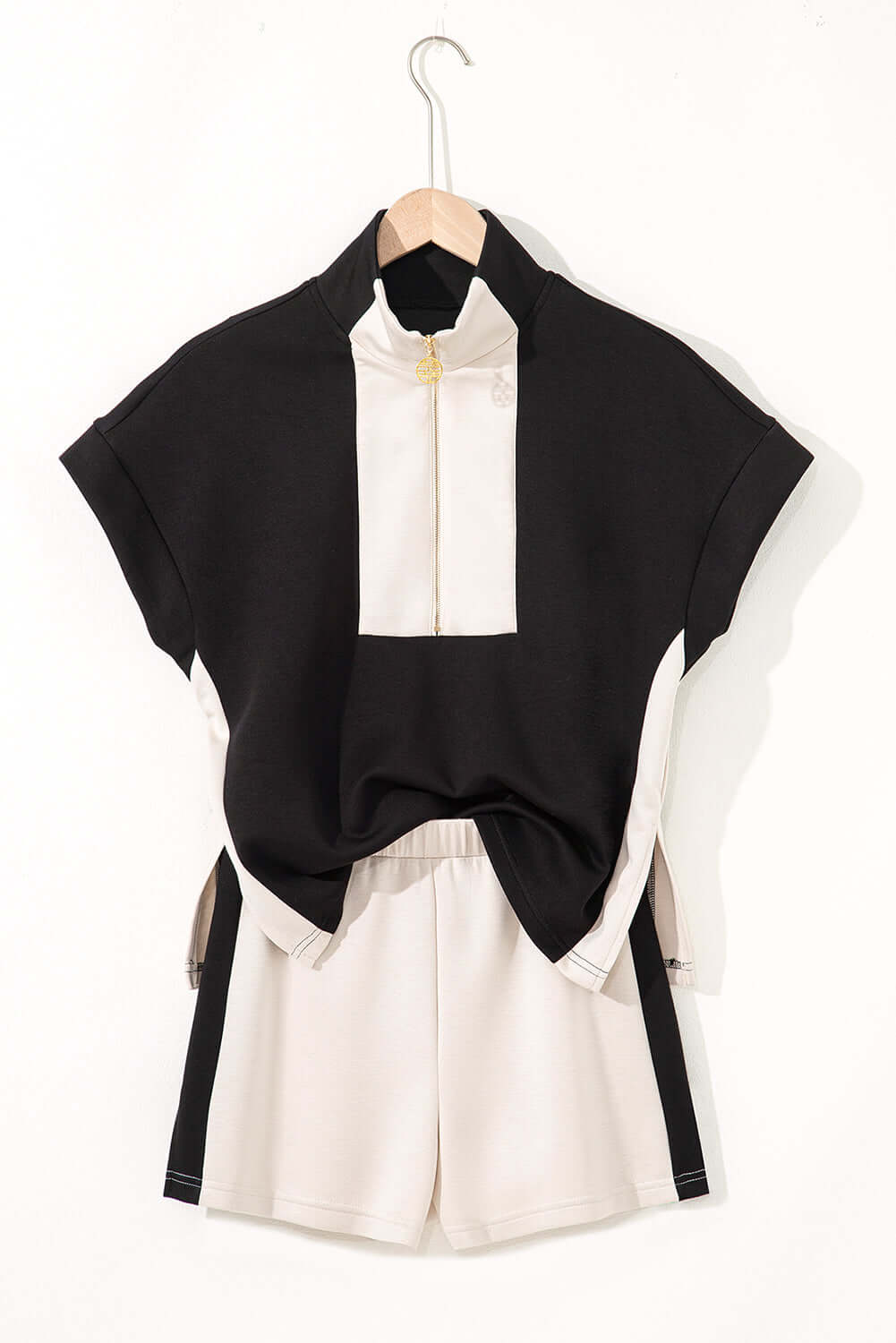 Monochrome Motion Zip Collar 2-Piece Set featuring black and cream colorblock design shorts and top.