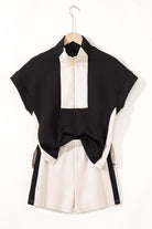 Monochrome Motion Zip Collar 2-Piece Set featuring black and cream colorblock design shorts and top.