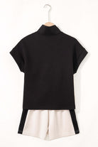 Back view of the METRO MODE monochrome shorts set featuring a zip collar top and cream-colored shorts.