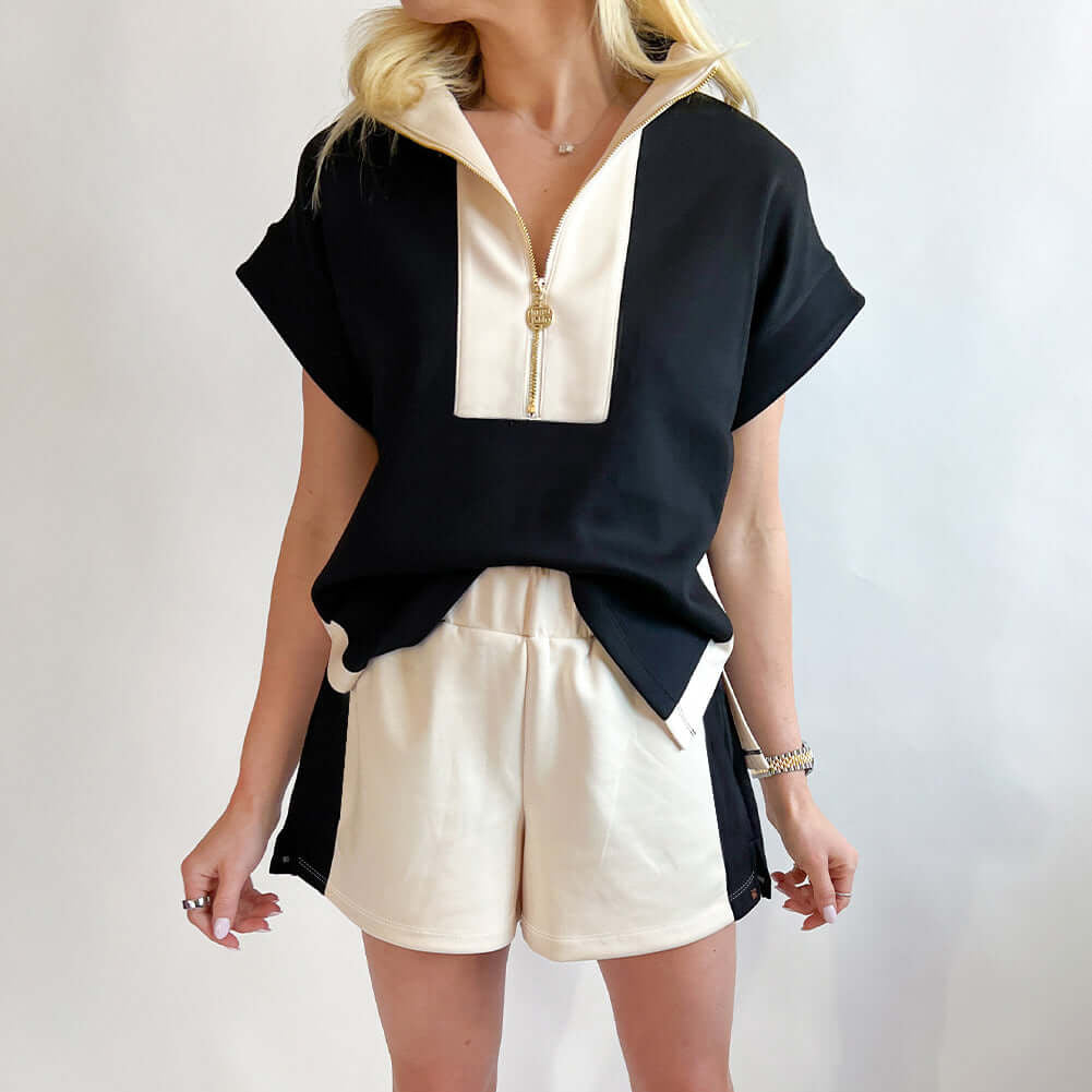 Monochrome Motion Zip Collar 2-Piece Set in black and cream, showcasing sporty-chic style and comfort.