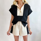 Monochrome Motion Zip Collar 2-Piece Set in black and cream, showcasing sporty-chic style and comfort.
