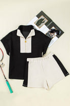 Monochrome Motion zip collar short set in black and cream colorblock, stylish and sporty design.