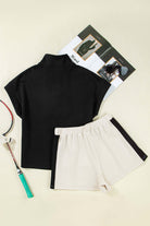 Monochrome Motion Zip Collar 2-Piece Set in black and cream, featuring shorts and a stylish zip collar top.