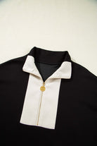 Black and cream zip collar top from the METRO MODE SHORTS SET, showcasing chic sporty style.
