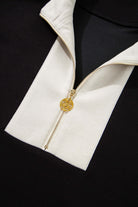 Close-up of the zip collar of a Monochrome Motion Set in black and cream, showcasing chic sporty style.