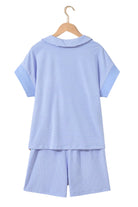 Back view of Misty Harbor 2-piece shorts set in sky blue stripes, featuring a polo top and drawstring shorts.