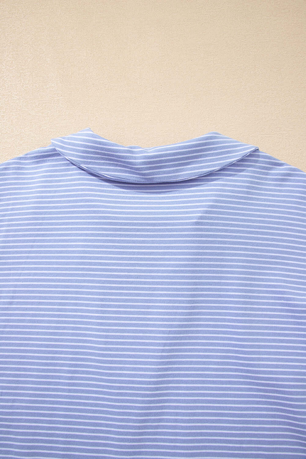 Back view of Misty Harbor blue stripe polo top, featuring a classic collar and soft fabric.